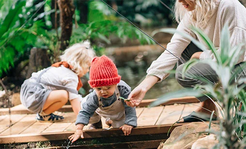 Family in a garden in Northern NSW with support from Summerland Bank’s Eco Home Loan.