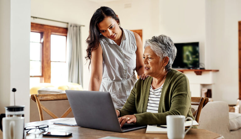 Mother and daughter at home comparing home loan options