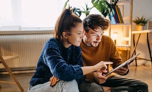 Couple reviewing renovation plans at home in Northern Rivers, supported by a Fixed Rate Home Loan from Summerland Bank.