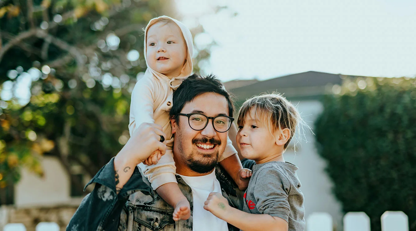 Family in Northern NSW outside their home, supported by Summerland Bank’s competitive fixed and variable home loans.