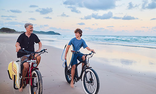 Northern Rivers father and son, enjoying a day at the beach after purchasing their first home with guarantor support.