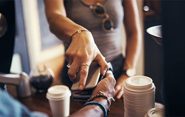 Woman paying with her phone