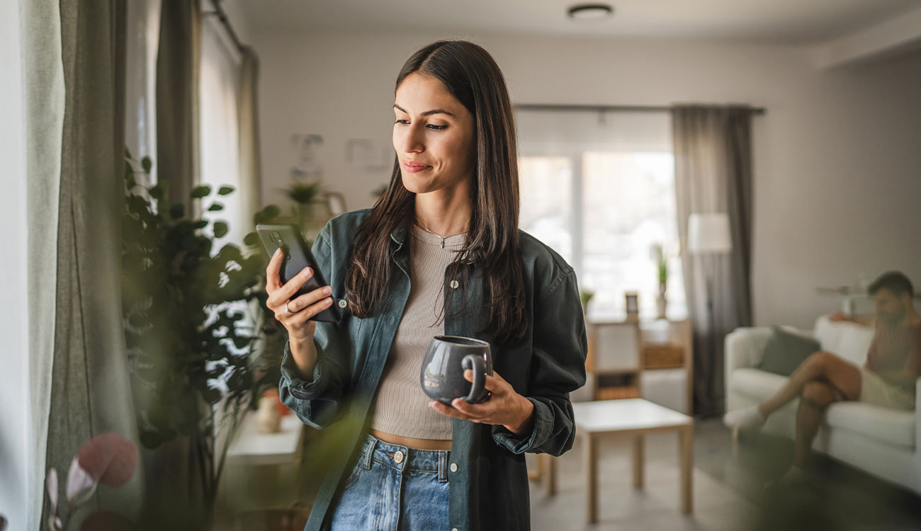 Woman using her mobile banking app at home.
