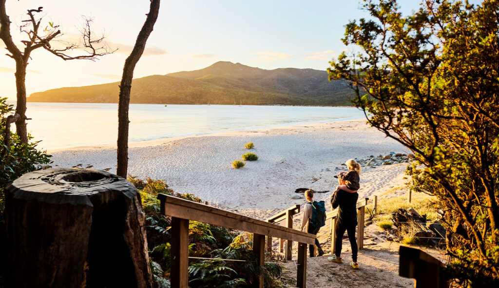 Family heading to the beach at sunset.