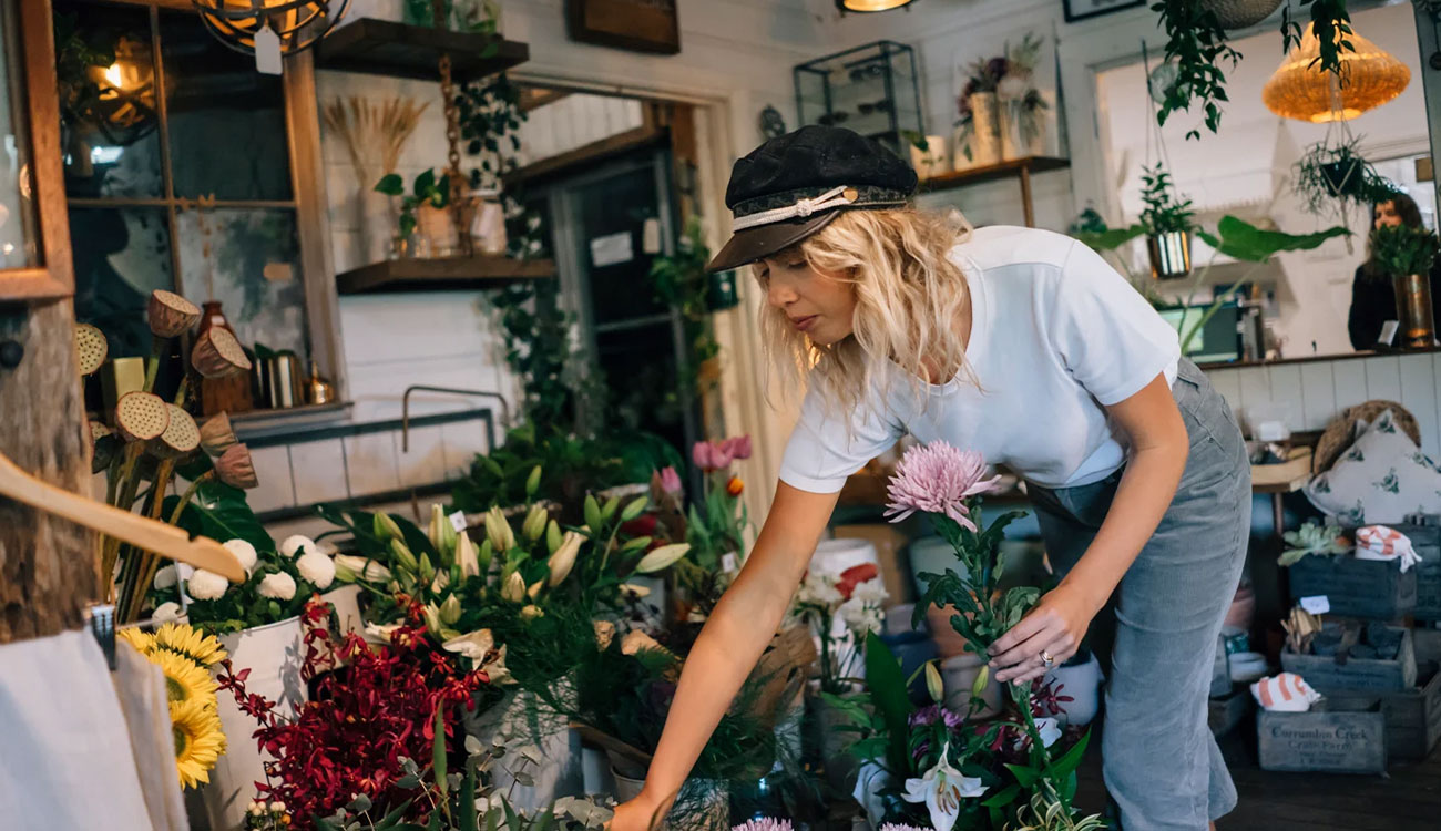 Woman arranging flowers in a florist shop.